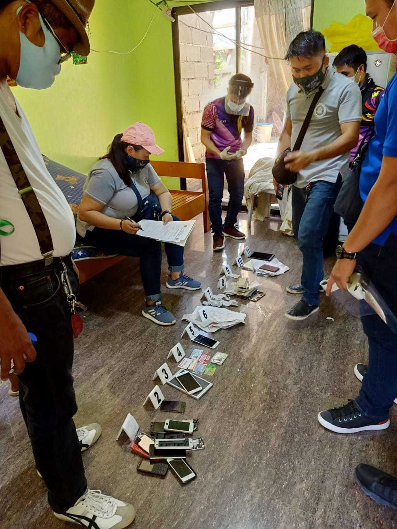 Operatives examining seized evidence Photo by WCPC MFU jpeg2020 05 PHP arrest in Mindanao 13 rescued 2020 05 PHP arrest in Mindanao 13 rescued Approved for Full Use