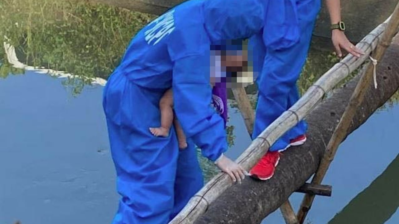 A 2 month old baby being removed from the place of abuse Photo by WCPC LFU