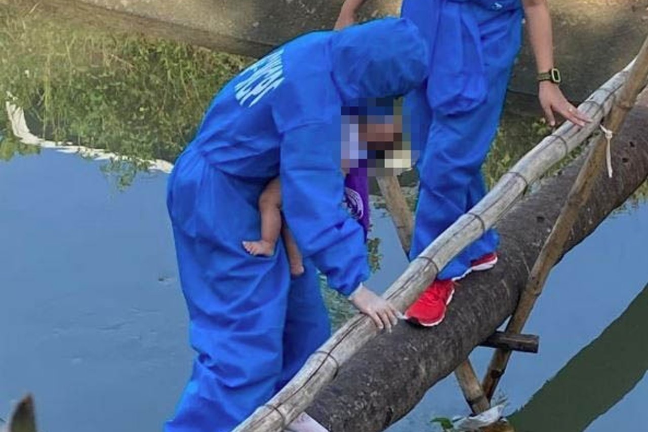 A 2 month old baby being removed from the place of abuse Photo by WCPC LFU